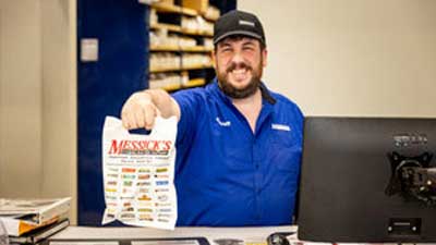 Vending machine repair spare parts man holding bag of parts